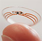 smart contact lens with tiny electronics on a fingertip