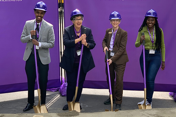 UW President Ana Mari Cauce (center left) and UW College of Engineering Dean Nancy Allbritton (center right) ceremoniously break ground along with engineering students Liban Hussein (l) and Aisha Cora (r) on the Interdisciplinary Engineering Building