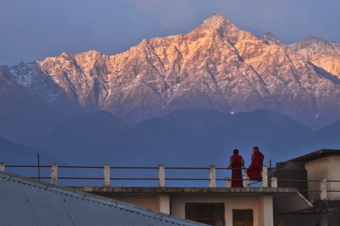 photo of monks at sunset