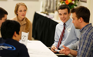 students and Career Center staff talking at a table