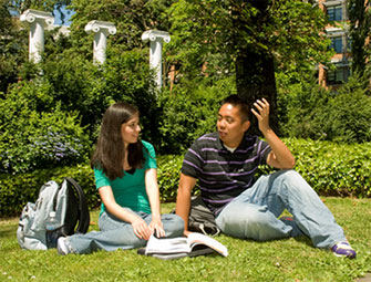 students on grass by UW columns