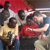 Doctoral student Carl Hartung demonstrates the UW tool, Open Data Kit, to local village phone operators in Uganda