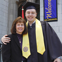 a new alumnus in graduation gown