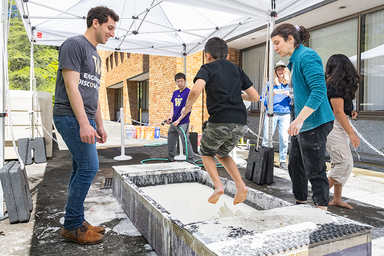 Young student trying out exhibitor booth experience