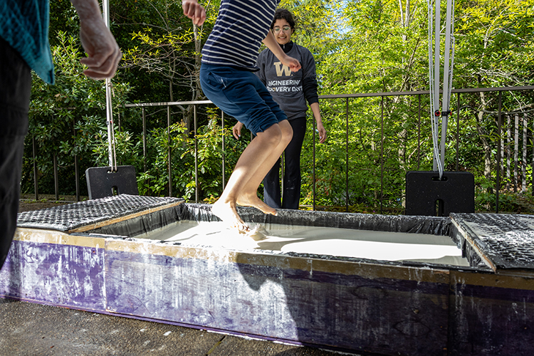 Young student trying out exhibitor booth experience