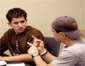 Two students using sign language while seated at a computer