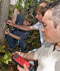 Electrical engineers Babak Parviz and Brian Otis and undergraduate student Carlton Himes (r-l) monitor a custom circuit powered by a tree.