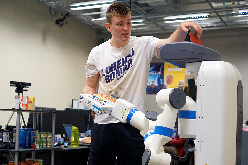 image of student with assistive robot