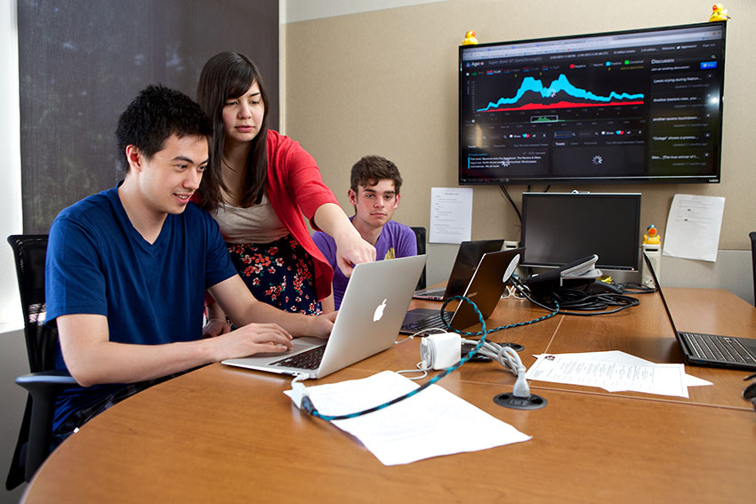 students looking at a laptop computer