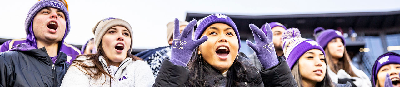 group of students cheering at a football game