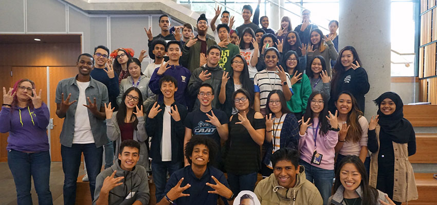 group photo of students making the 'w' sign