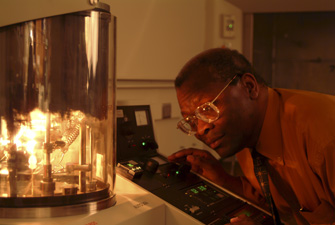 Professor Sam Jenekhe examines an apparatus in the lab