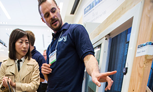 student team member shows a sensor on a window frame