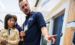 student  team member shows a sensor on a window frame