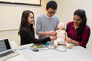 students demonstrating infant breathing monitor in lab