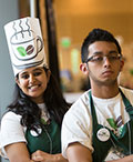 two members of Decaf Style team with chef's hat and aprons