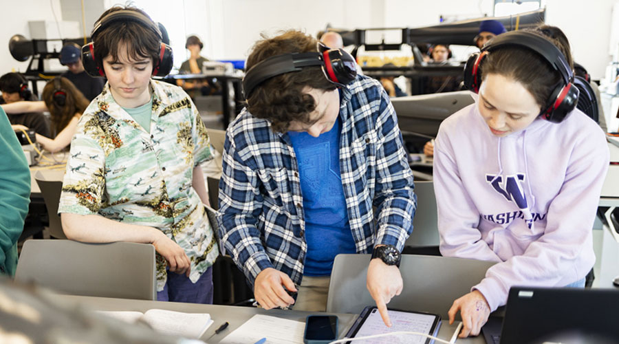 Students wearing ear protection working together in IEB lab