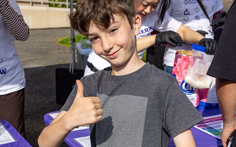 Discovery Days visitor holding up a thumbs up
