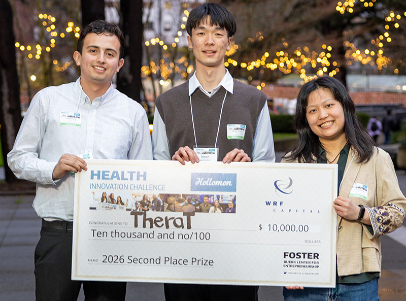 Students holding large prize check for TheraT awarding them $10,000