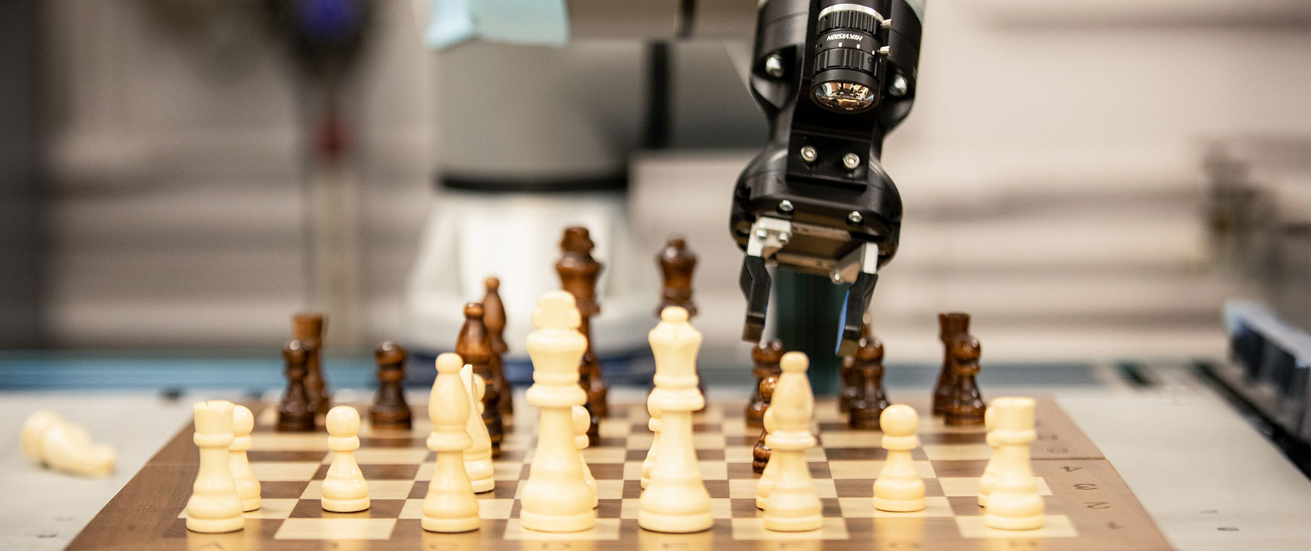Robot arm playing with chess board