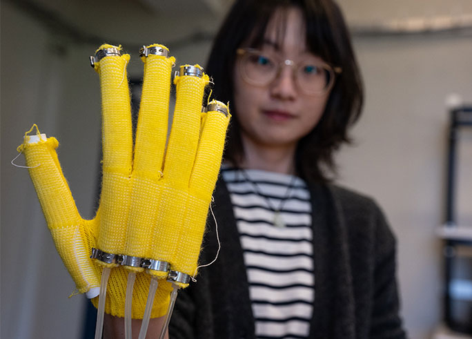 Yiyue Luo holding up glove