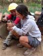 EWB student works on pipe with Bolivian child