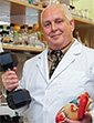 Michael Regnier holding model of heart and a heavy weight