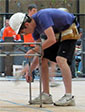 student building assembling a steel bridge