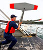 NOAA's Nick Morgan prepares to launch a drone. Photo: John Lok, Seattle Times