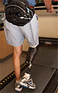 patient with artificial leg wired to tracking device in fanny pack