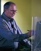 Craig Mundie demos new technology at Kane Hall lecture; from photo by Patrick Riley, UW Daily
