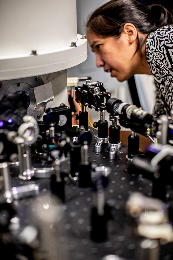 Kai-Mei Fu inspects equipment in the Quantum Defect Laboratory