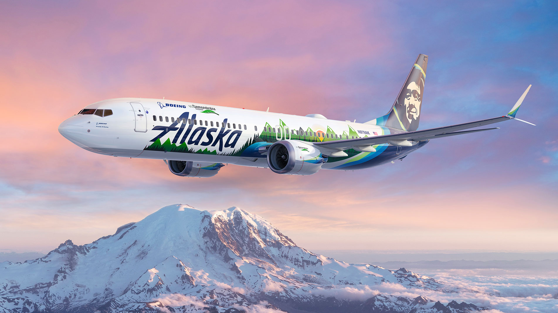 A Boeing Alaska Airline plane flying over snow capped mountains