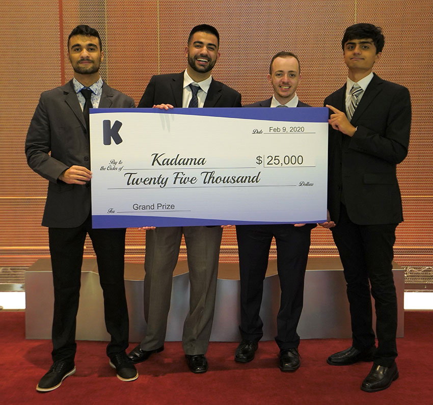 Four people holding a big check