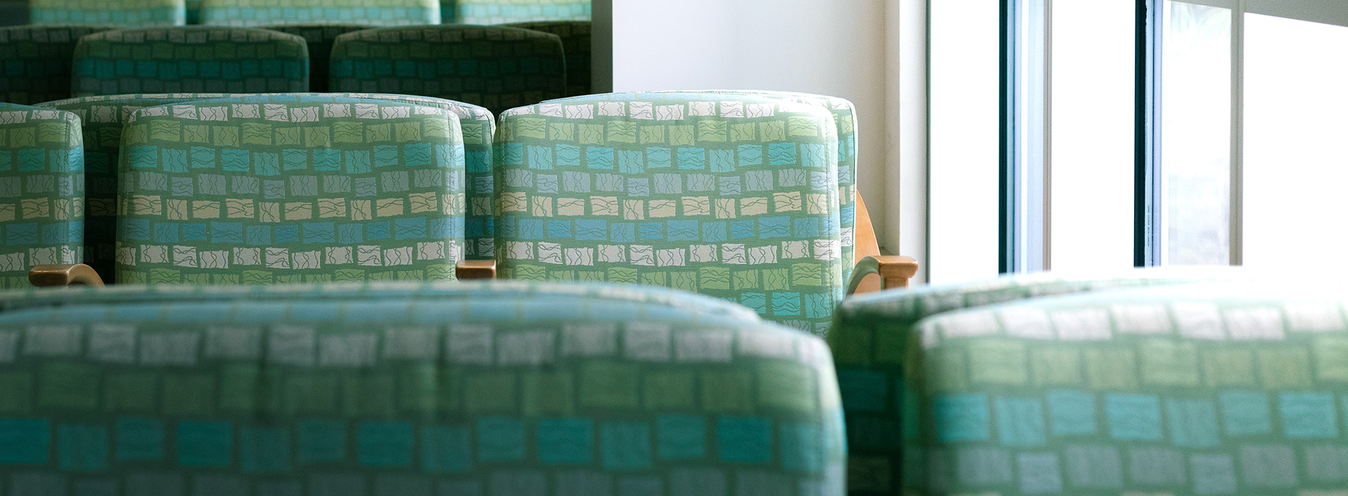 Green chairs in an heath-care waiting room