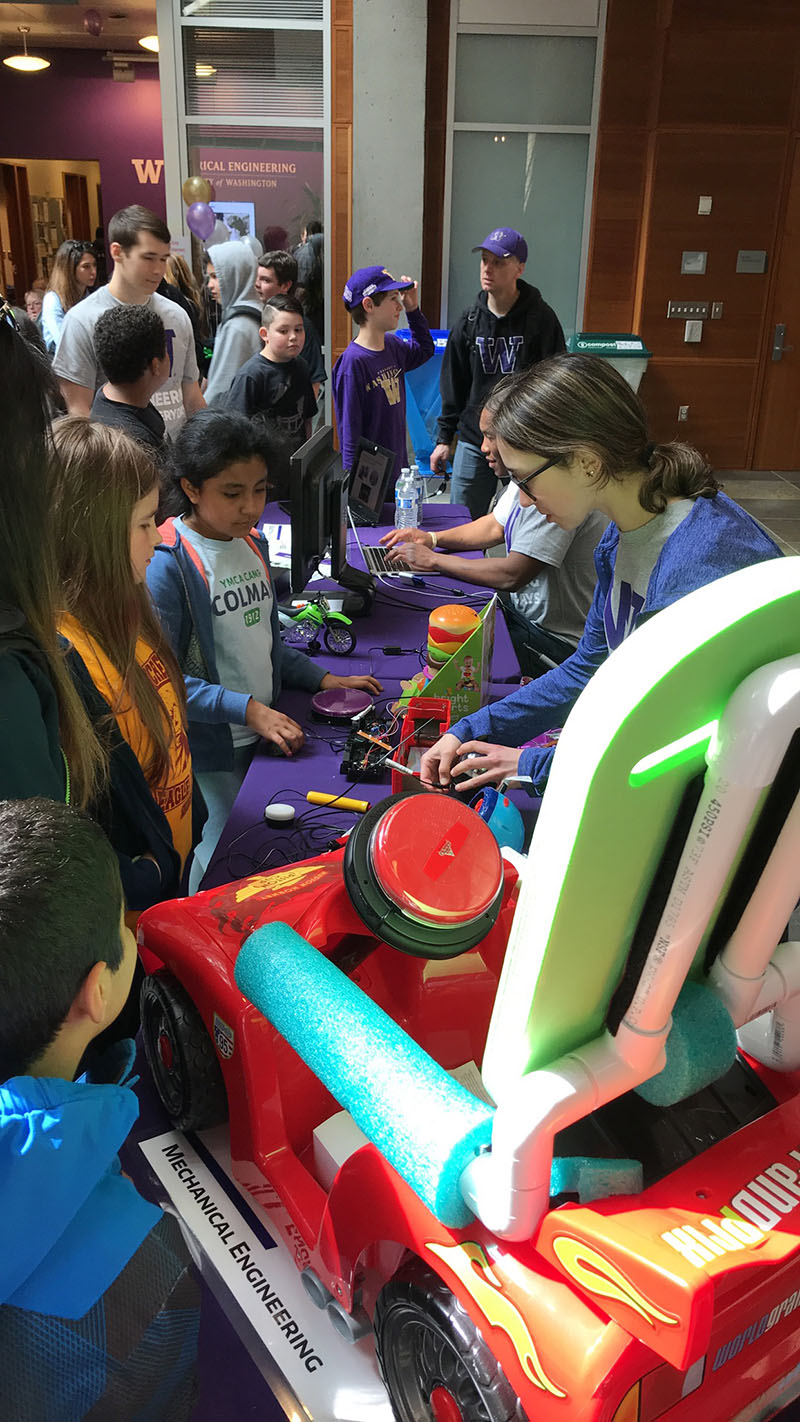 photo of students examining toys