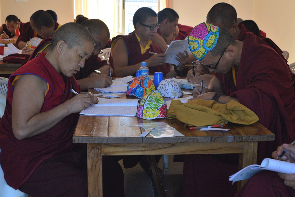 photo of monks working on brain hats