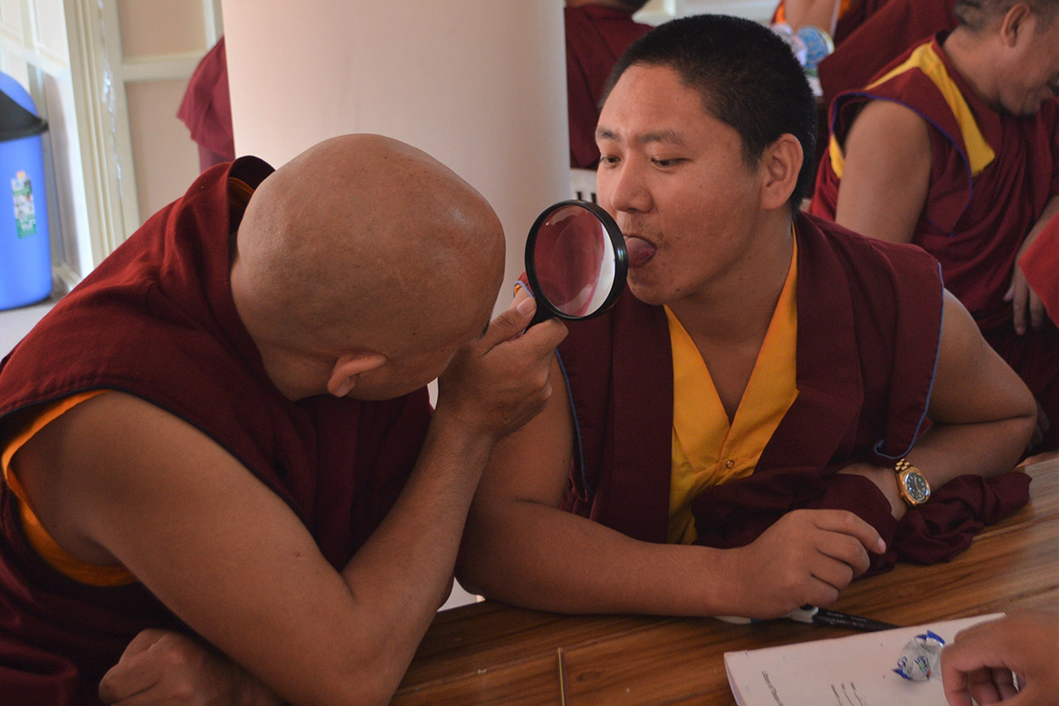 photo of monks examining the tongue with a magnifying glass