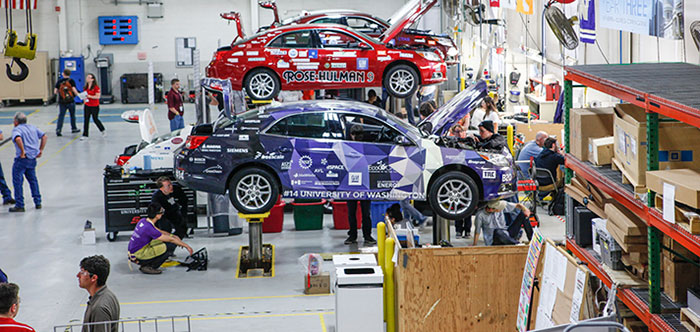 UW EcoCAR2 on a lift getting ready for competition