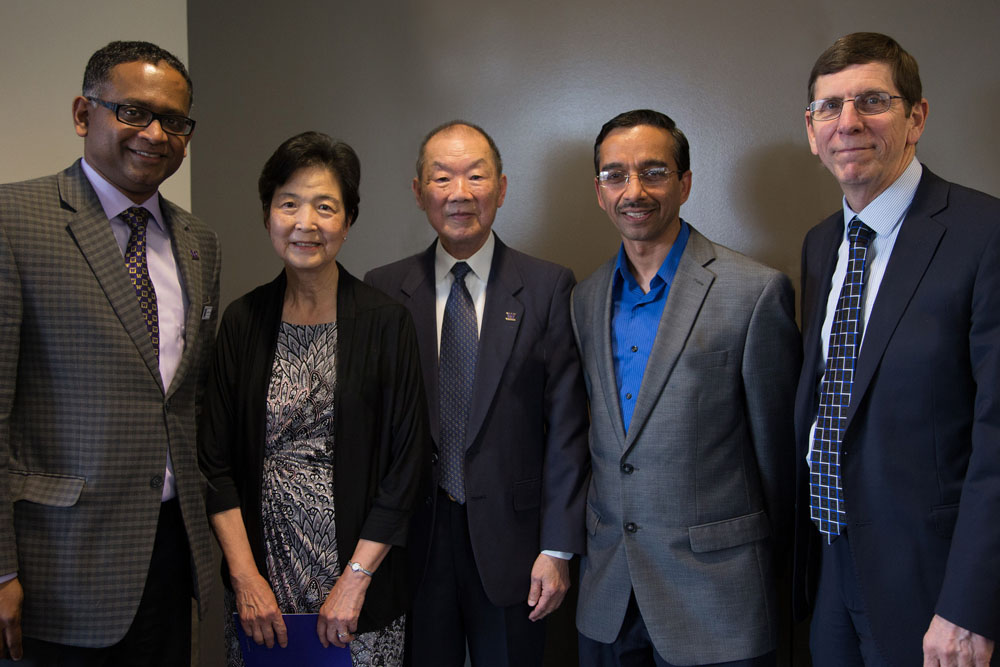 Engineering professors standing with the Hwangs