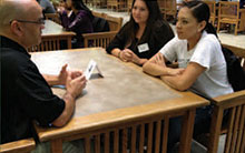 alumnus talks to students at event
