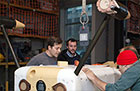 UW researchers Ben Rush, Nick Michel-Hart, James Joslin and Paul Gibbs prepare to test the monitoring device underwater in a tank on campus. Credit: Applied Physics Laboratory, UW