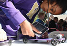 girl working on solar powered model car