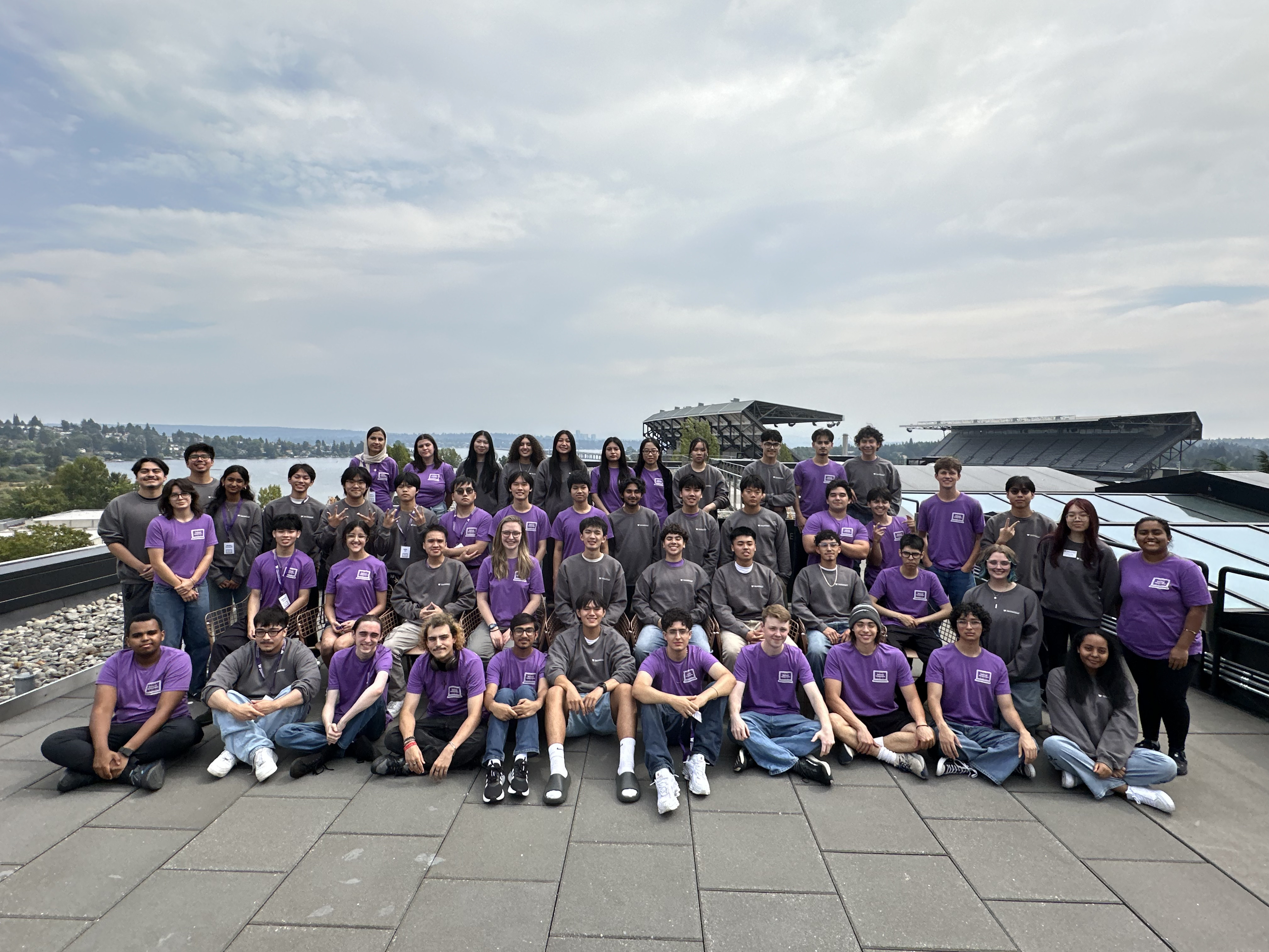 Image of a group of students with Husky Stadium and Union Bay in the background. 