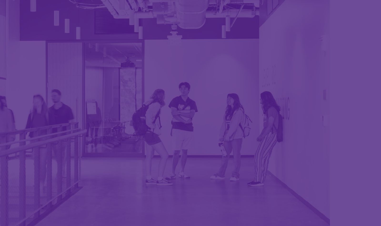 Students chatting in a hallway outside of class in the Interdisciplinary Engineering Building