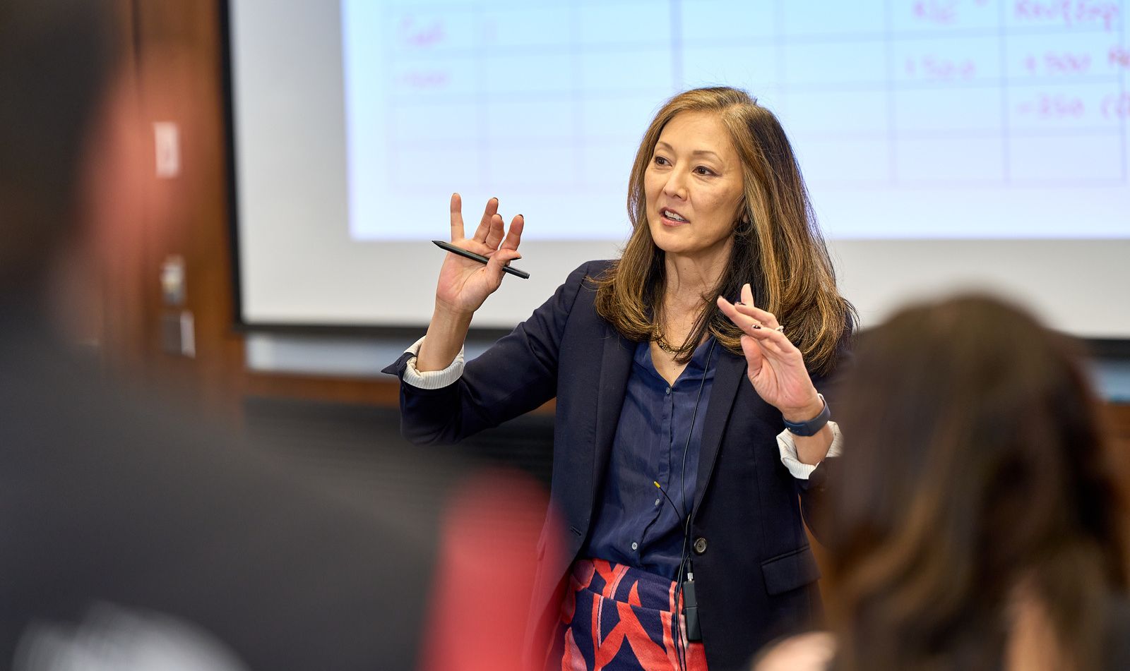 Professor gesturing in front of class