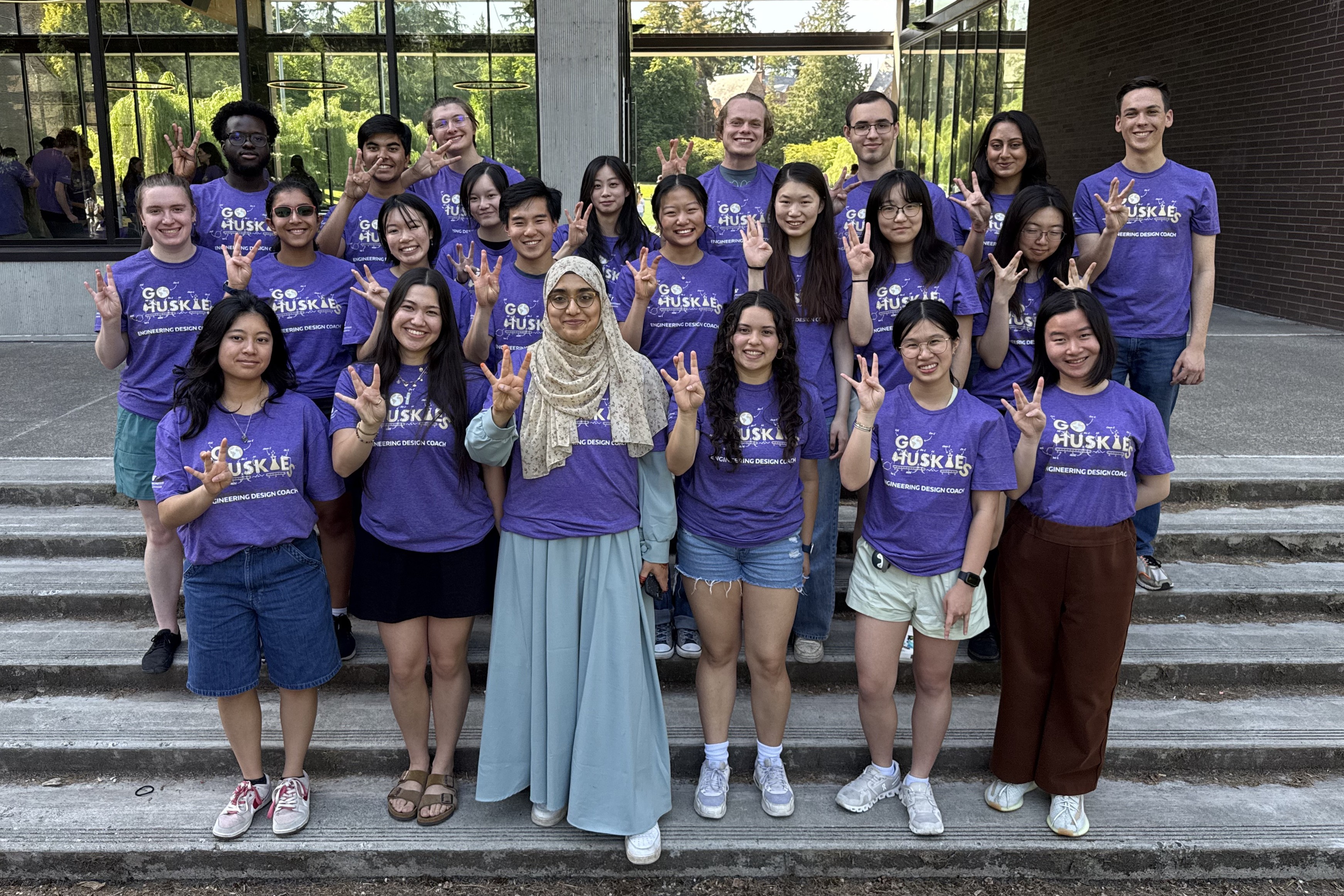 Group photo of Engineering Design Coaches outside in matching purple t-shirts.