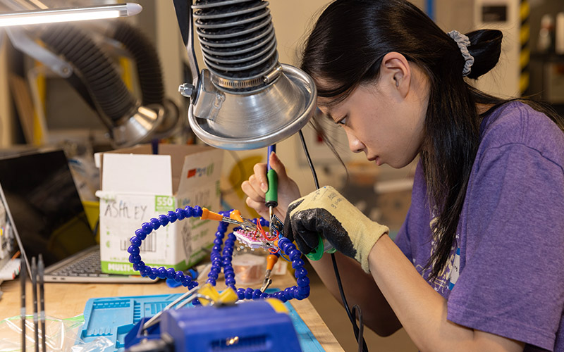 Student working with equipment in workshop