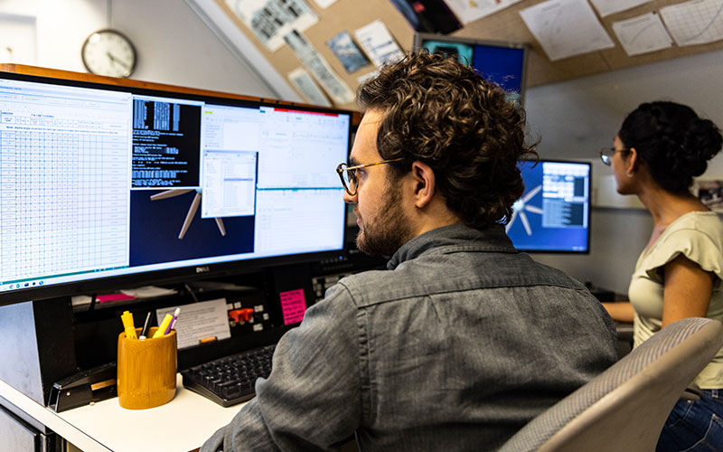 Researchers looking at computer screens working in Kirsten Wind Tunnel