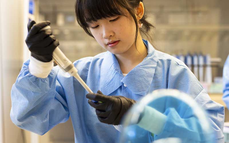 Engineering student conducts laboratory testing with precision equipment